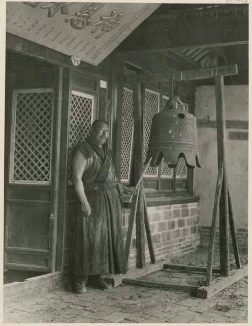 Lamas at the Little Poplar Tree Temple ringing the bell