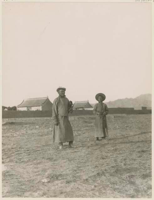 Two Mongols in the country wearing hats