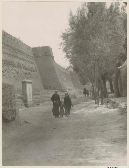 Jeweler with his wife and child walking down East Wall Street