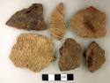 Coarse earthenware body and rim sherds, some undecorated, some cord impressed, some incised, some rocker dentate; bone fragment