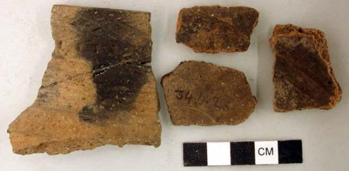 Ceramic, earthenware rim and body sherds, incised and punctate design, one sherd is mended to 34424