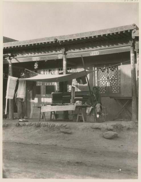 Cotton seller in his booth on the main shopping street