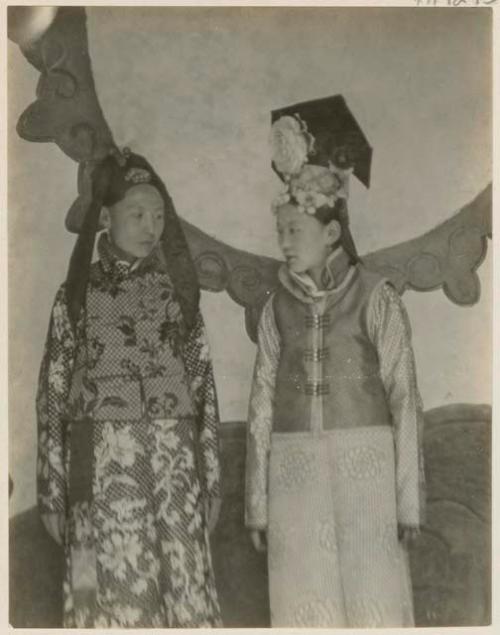 Native lady and Manchu lady outside in their regalia