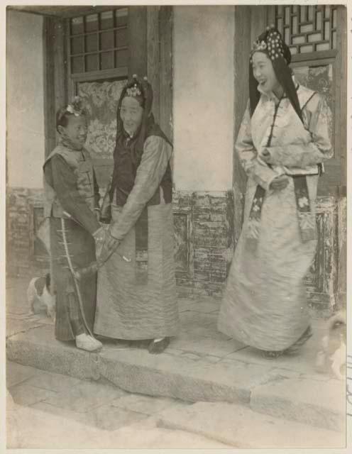 Mongol bride laughs with mother and sister