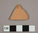 Red earthenware sherd with unglazed exterior and no remaining interior surface