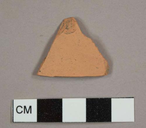 Red earthenware sherd with unglazed exterior and no remaining interior surface