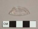 Colorless curved glass fragment, either a flared rim or lip to a bottle or a base to a stemware vessel