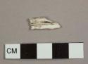 White plastic handle fragment, most likely from utensil