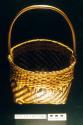 Plaited cane basket with handle