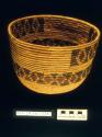 Coiled bowl-shaped basket of marsh grass with straight sides