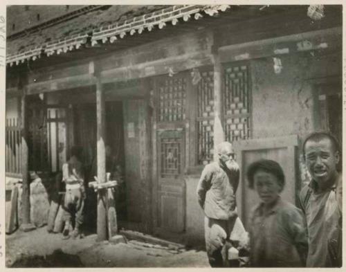 People standing in front of a carpenter's shop