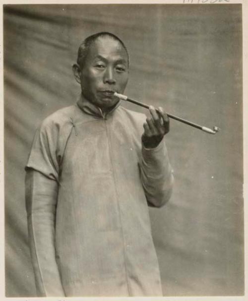 Portrait of Chinese teacher and transport manager with pipe