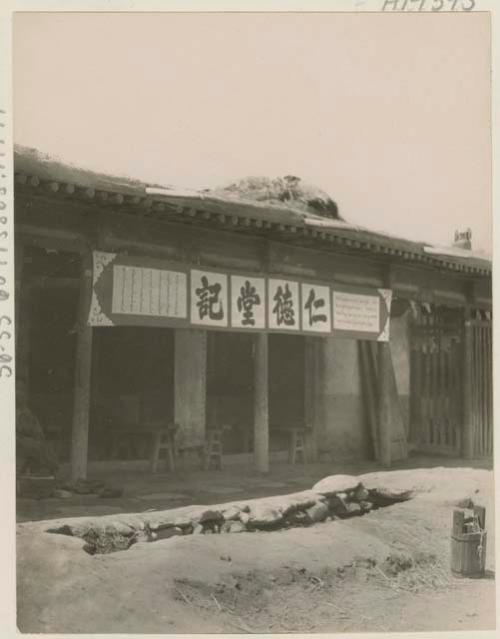 Shop front with a sign in three languages