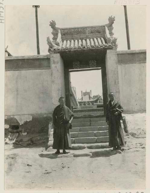 Two young lamas outside side entrance to lama temple