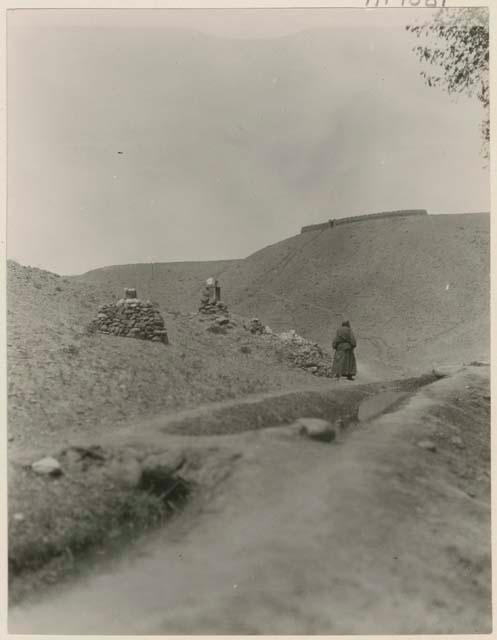 Mani stones, with piles of small stones below them