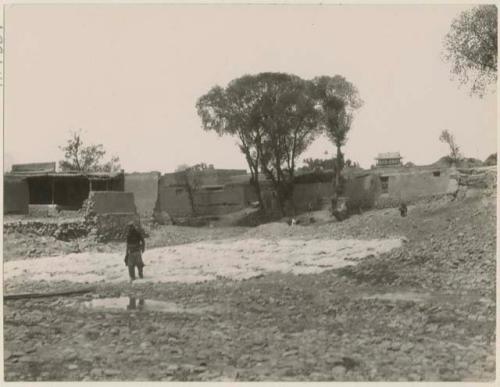 Boys washing and preparing sheepskins in brook