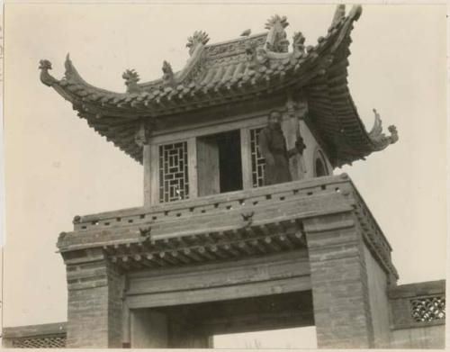 Man standing on tower inside south gate