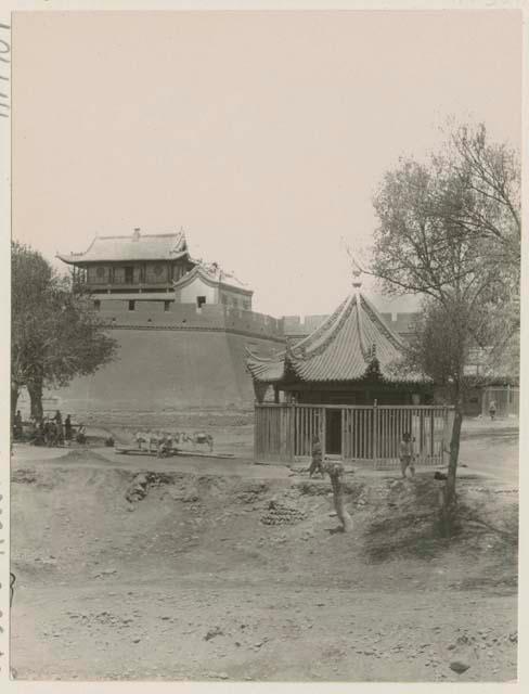 Small shrine with large prayer wheel inside, in the market square