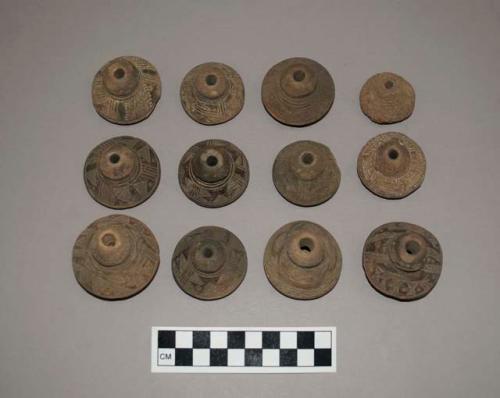 Ceramic spindle whorls, round, incised decoration