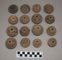 Terra cotta spindle whorls ornamented with incised lines