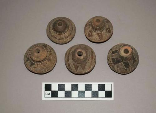 Ceramic spindle whorls, round, incised design