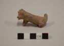 Fragment of animal figurine, including trunk, mouth & tail. plain ware. 6.0 x 2.