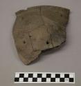 Ceramic, earthenware rim sherd, cross-mended, incised and cross-hatch incised decoration, four perforations