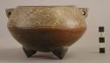 Large maroon incised ware tripod bowl with open mouth and designs all around