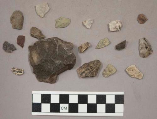 36 stone chips; 17 quartz chips; 1 bone fragment; 7 pieces unglazed pottery (?)