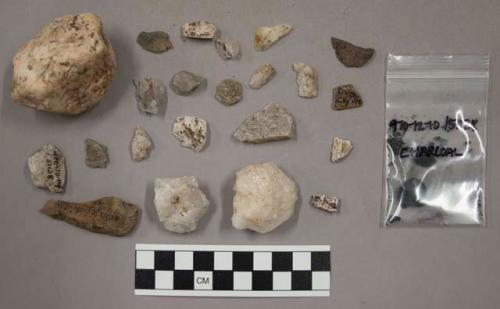 37 pieces quartz (1 whole rock); 11 pieces stone; 1 chip pottery(?), unglazed (?