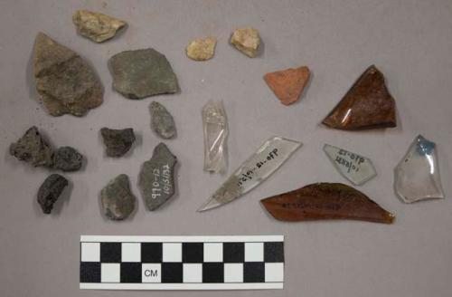 8 lithic fragments; 6 glass fragments; 4 cinders; 1 retouched fLake