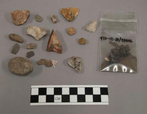 6 fragments quartz and limestone; 11 fragments stone; 1 pebble; sample of earth