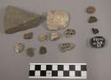 9 fragments stone; 7 fragments limestone; 2 fragments coal-like material; 2 frag