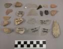 10 glass fragments; 94 lithic fragments; 4 pottery; 5 charcoal; 1 quartz scraper