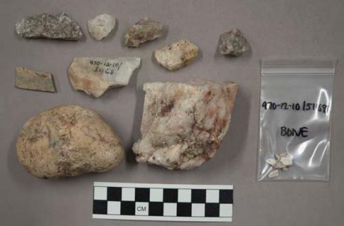 Fragment bone; 3 pieces chalk-like material; 14 fragments stone; 2 rocks (unbrok