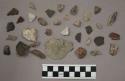 21 pieces quartz; 1 piece bone; 4 buff-colored fragments (stone or pottery?); 55