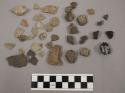 Fragments charcoal; 13 fragments unglazed pottery; 18 fragments quartz and limes