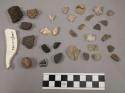 87 stone fragments; 3 fragments bone?; 1 fragment glazed pottery; 1 fragment gla