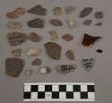 28 stone chips; 2 pcs unglazed pottery; 1 piece glass; 3 pcs coal-like substance