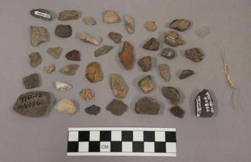 21 chips limestone and quartz; 13 pcs unglazed pottery; 50 stone fragments