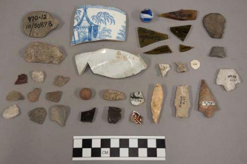 10 glass, 10 pottery (1 jackfield), 1 shell button, 6 potsherd with blue glaze,