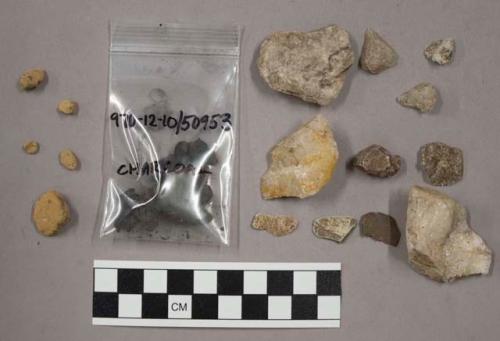 24 fragments quartz and limestone; fragments soft, yellow rock; charcoal fragmen