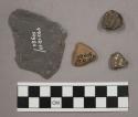 Stone fragment, pottery sherds