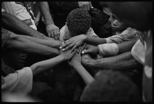 B/W image: Kaugere Bulldogs rugby league, team prayer before a game at Kaugere Oval, Port Moresby