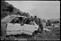 B/W image: Kids inside a wrecked car, Baruni garbage dump, Port Moresby