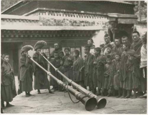 Lamas demonstrating playing horns