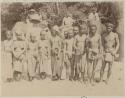 Group of people with men on elephants in background