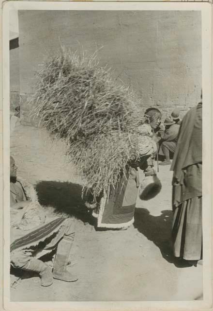 Girl carrying straw