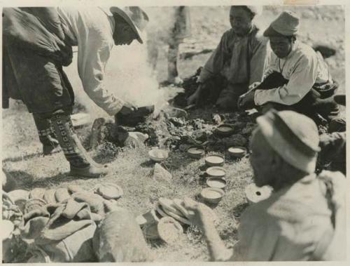 Men eating tea and Tsamba