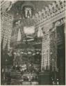 Detail of temple roof interior and superimposed large gold idol